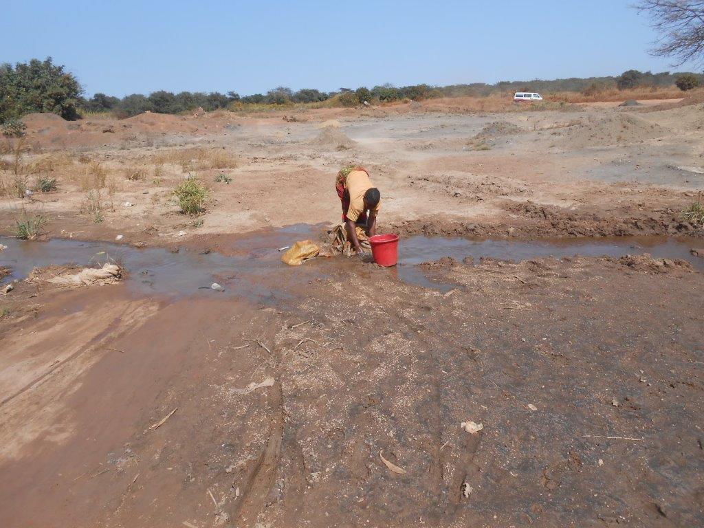 Woman working at an artisanal mine in DRC