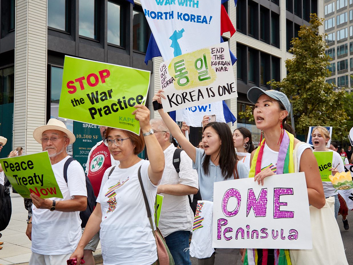 group of Koreans marching with posters