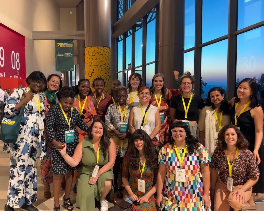 group of women posing for photo with yellow lanyards around neck