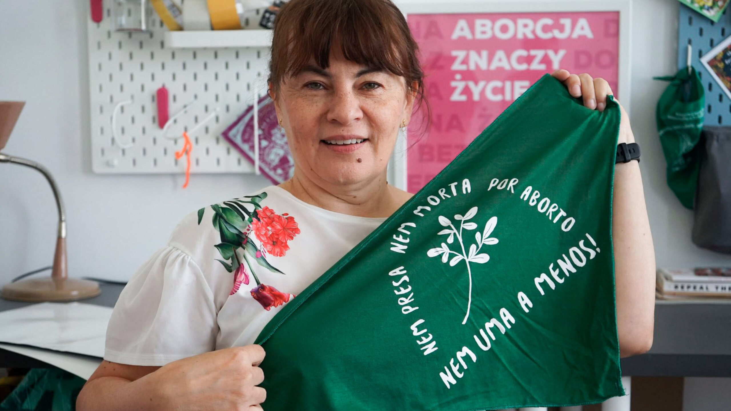 women holding green triangular material