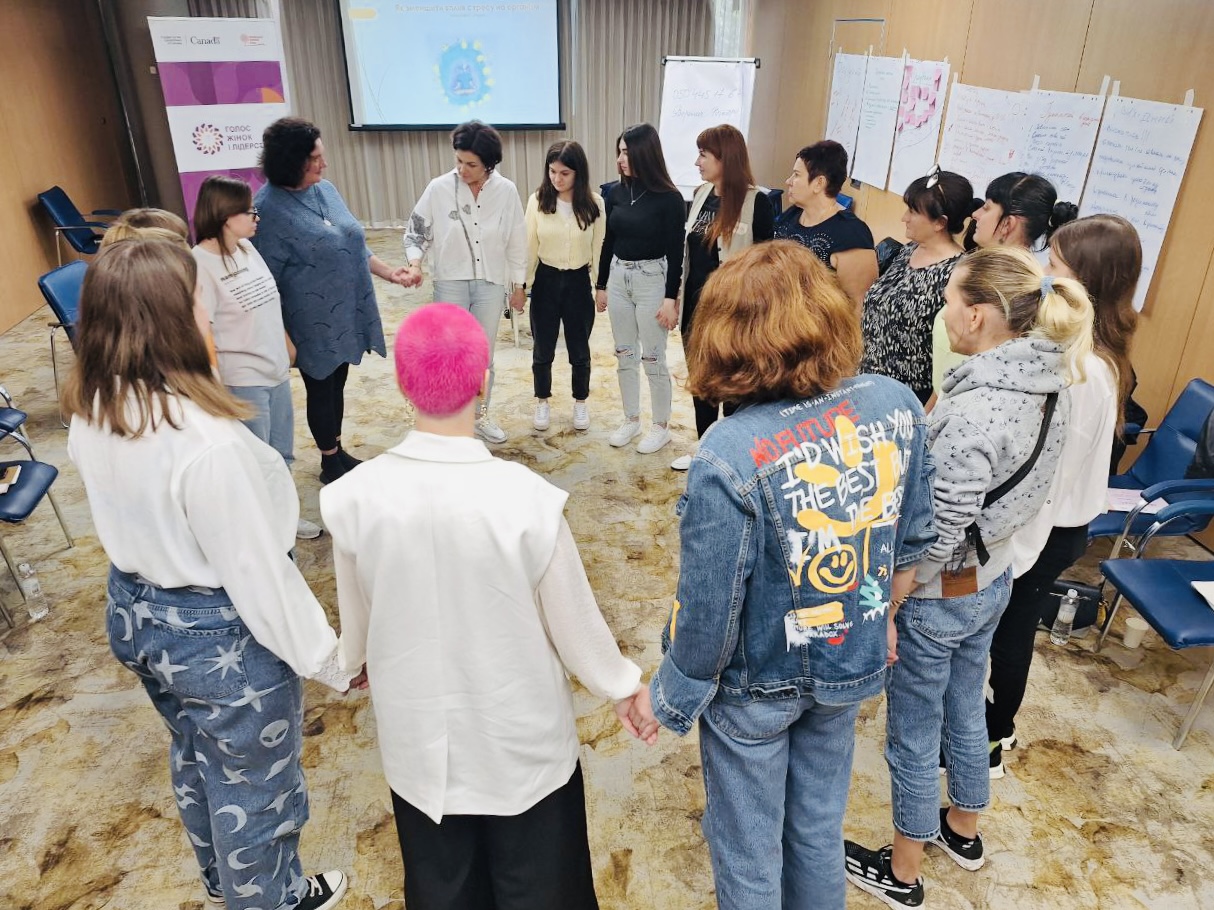 group of people holding hands in a circule