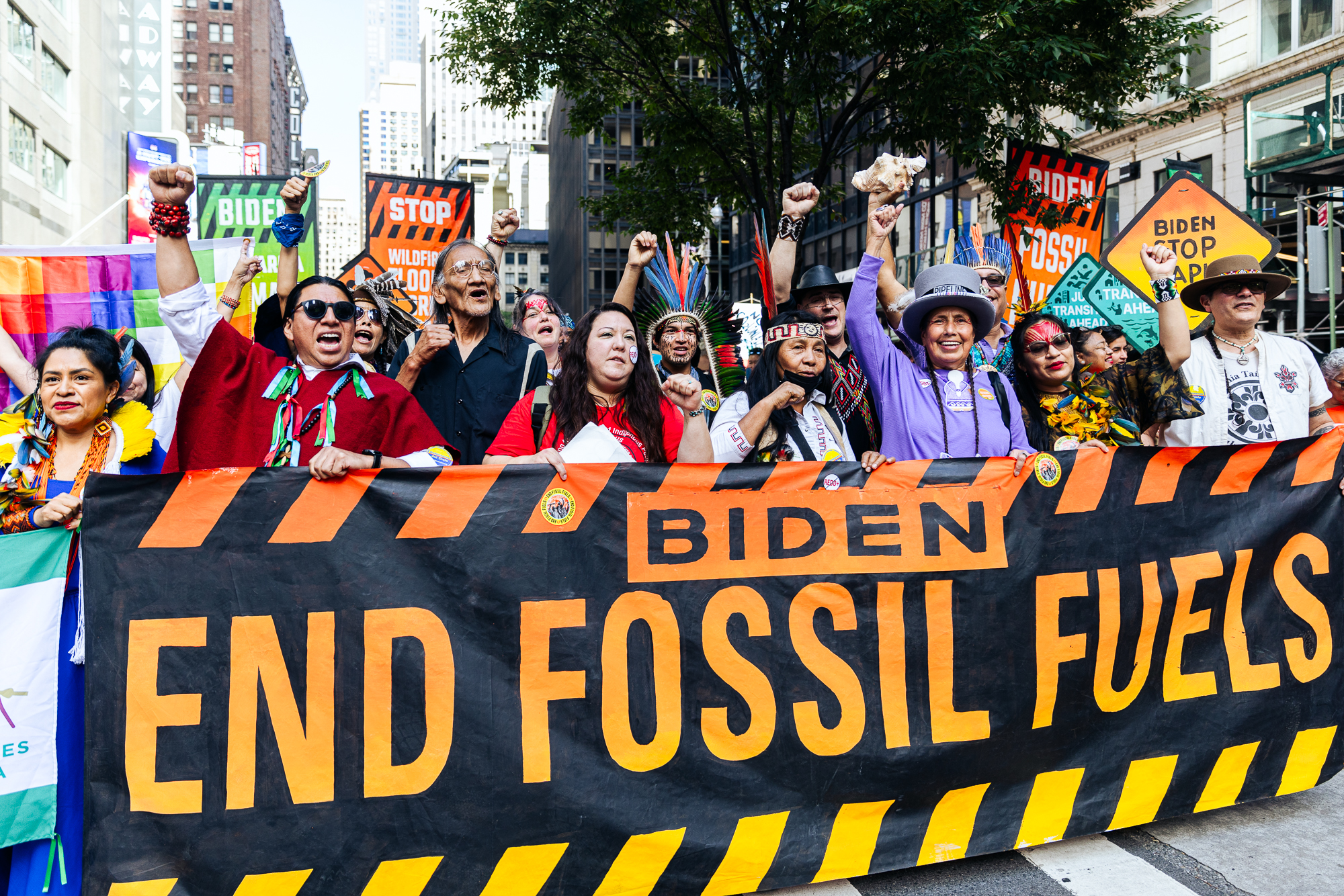 group of people marching with hands held above their heads